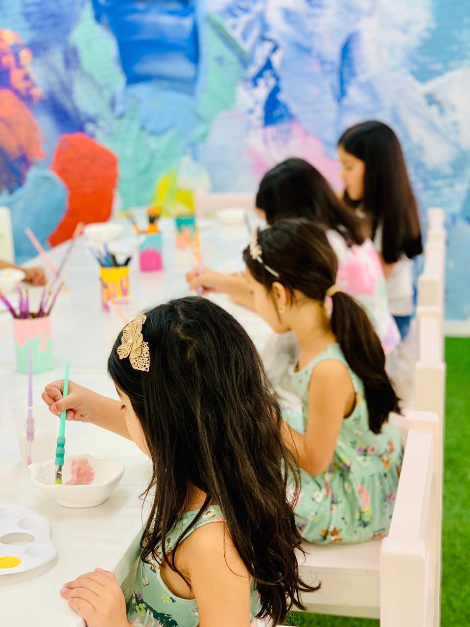 Children painting ceramics at The PaintBrush studio